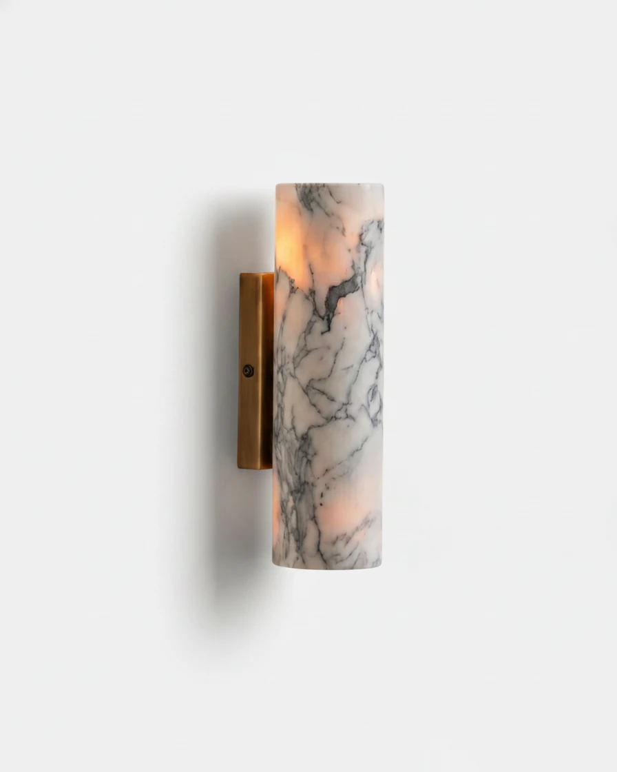Marble wall sconce PORTORO No.01, viola calacatta marble cylinder glowing on a brass bracket