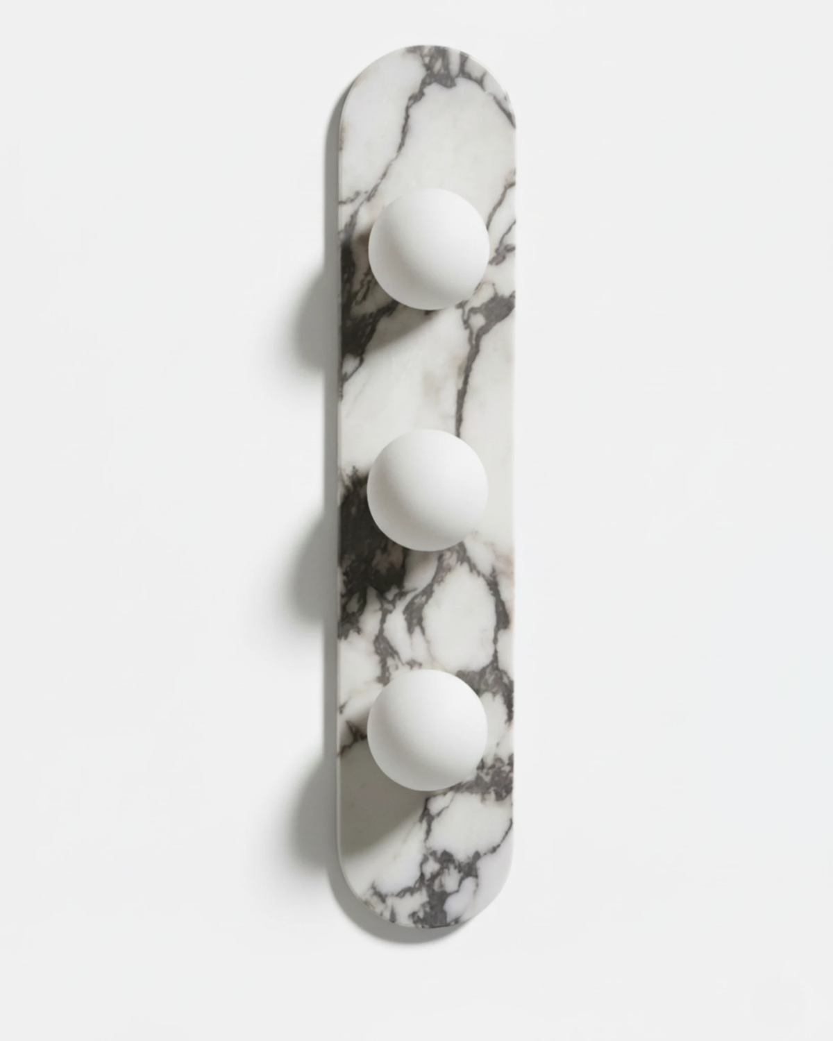 Marble wall sconce AVOLA No.01 triple globe, three opal glass globes on a tall oval marble backplate, unlit