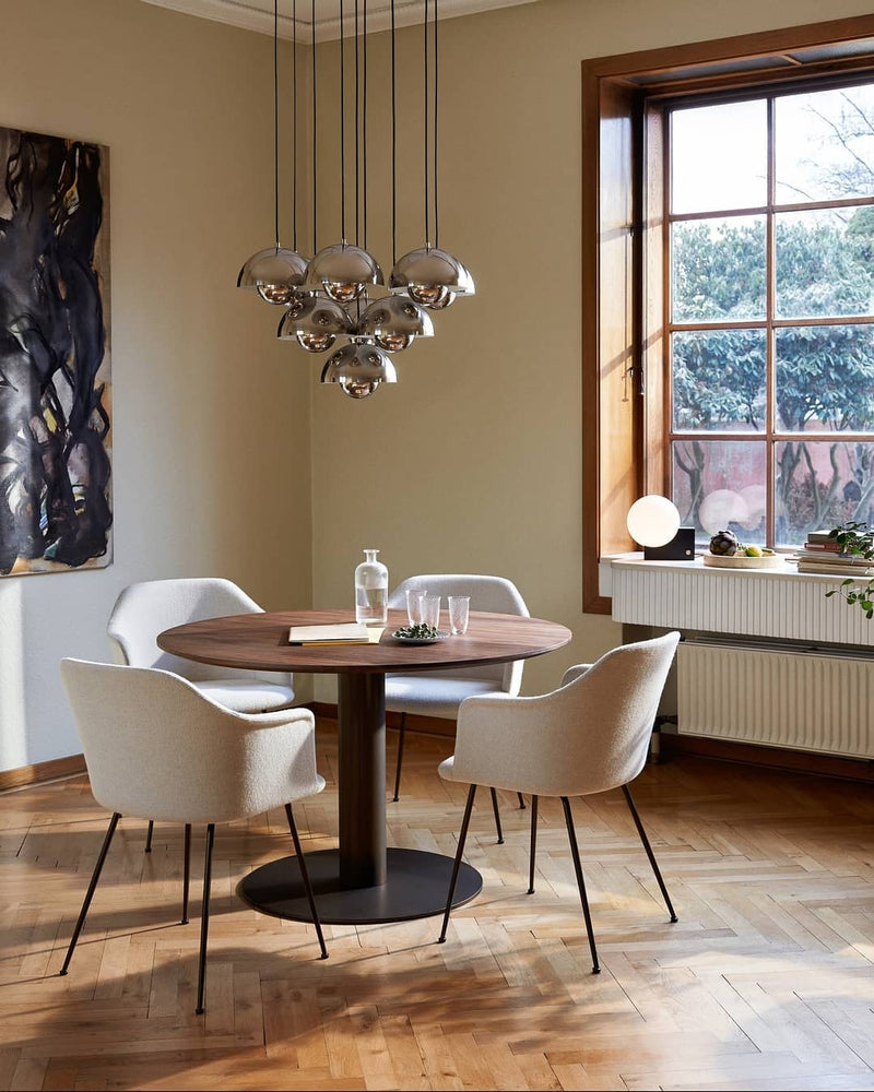 Modern chandelier FLORA No.01 in chrome mirror over a round dining table with cream chairs beside a tall window