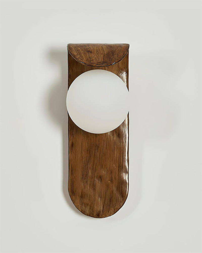 Modern wall sconce ANIMA No.02 unlit, hand-sculpted walnut-tone polymer body holding a white opal globe