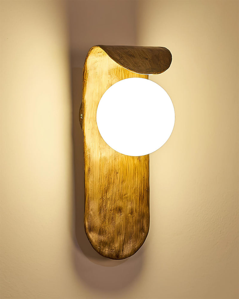 Modern wall sconce ANIMA No.02 close view, opal globe lit against the textured walnut-tone polymer body