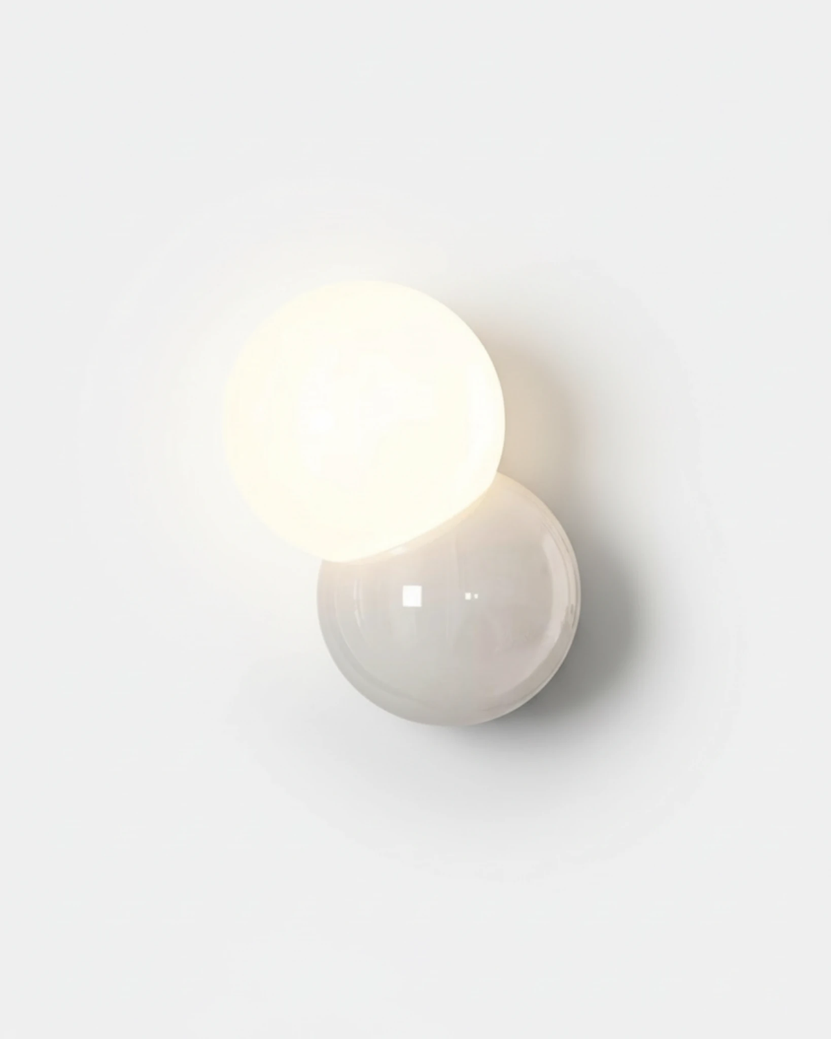 Modern wall sconce AURA No.01 in pure white, twin spheres with the upper globe switched on