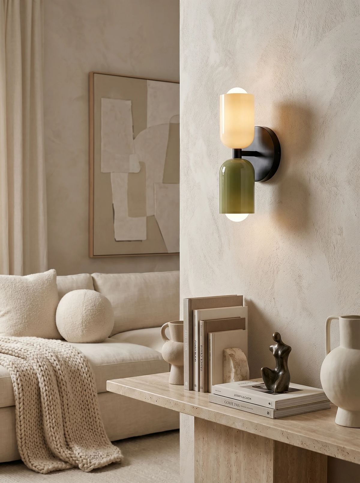 Modern wall sconce TORINO No.01 with cream and green capsules glowing above a cream sofa next to abstract art
