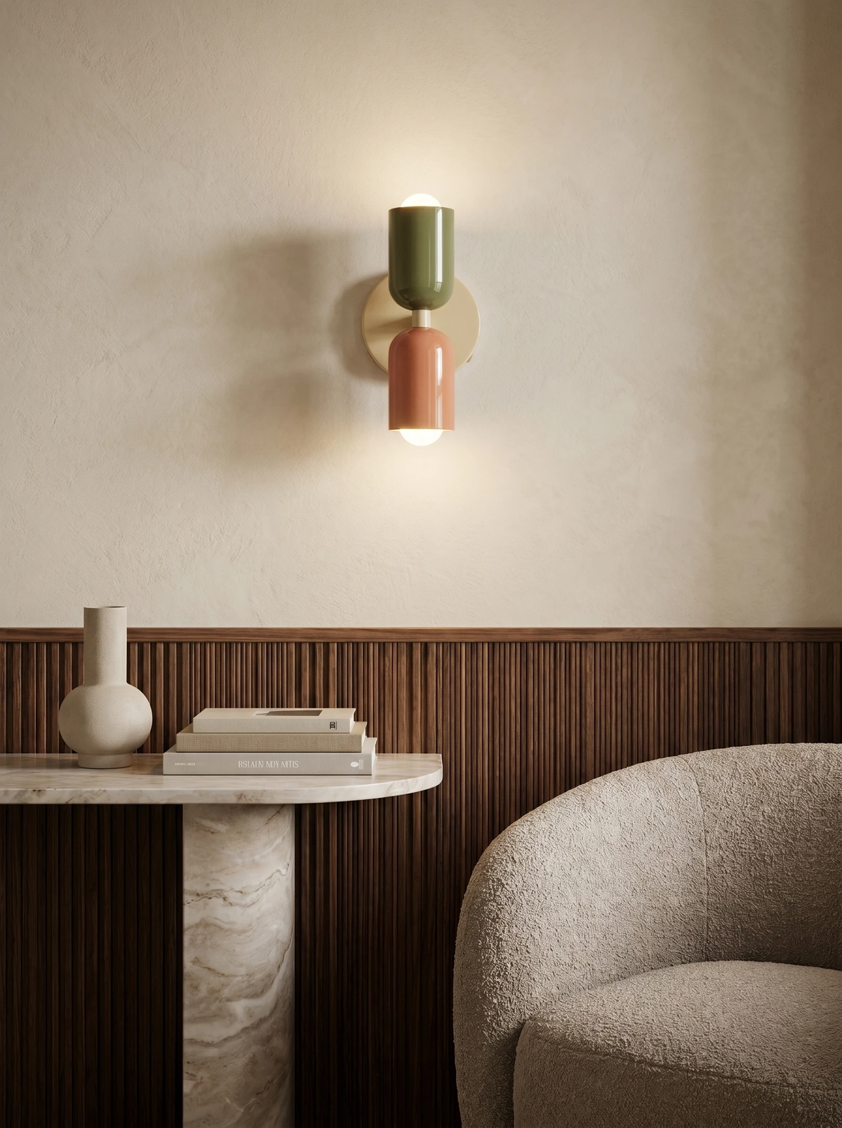 Modern wall sconce MURO No.02 in sage and pink, switched on above a marble console table and a boucle armchair