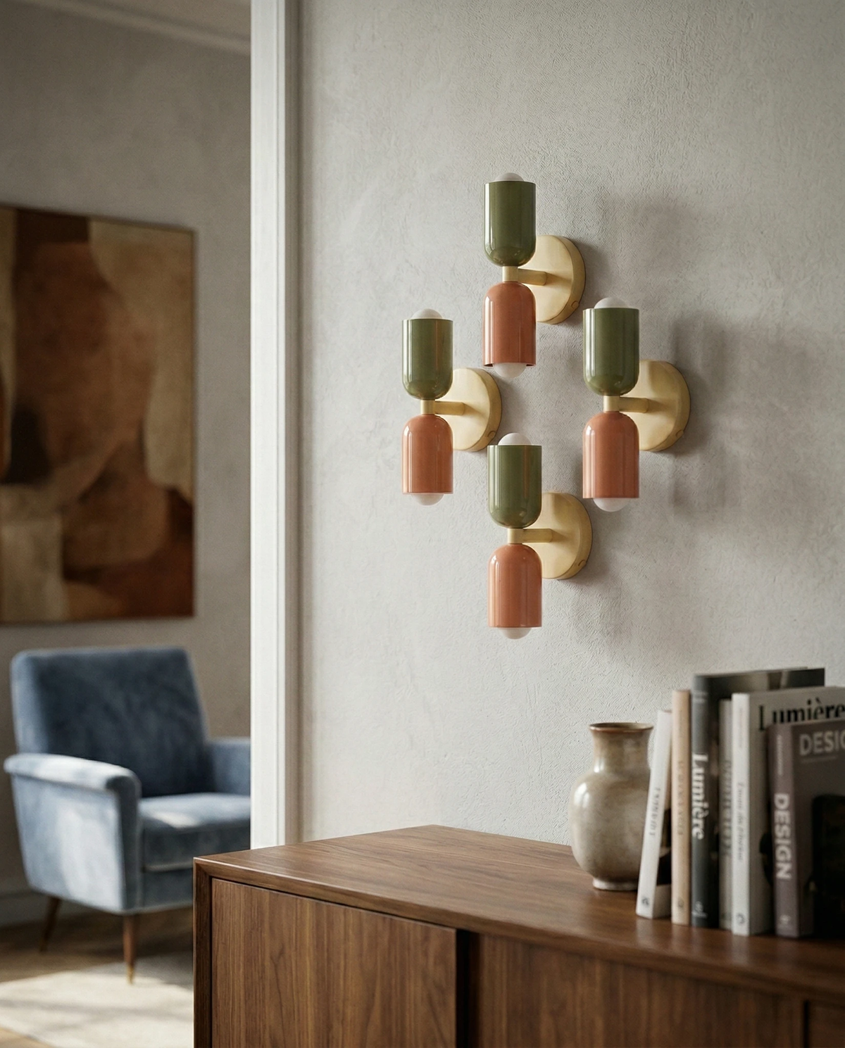 Cluster of five modern wall sconces MURO No.02 in sage and pink above a walnut sideboard with books and a vase