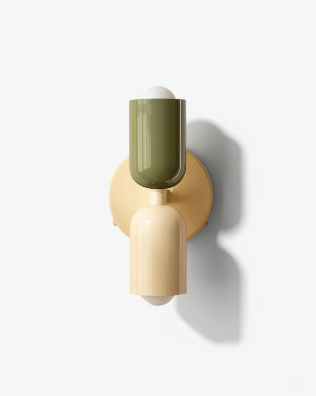 Modern wall sconce MURO No.02 in Sand & Sage, sage green top and cream bottom capsule with a round brass backplate
