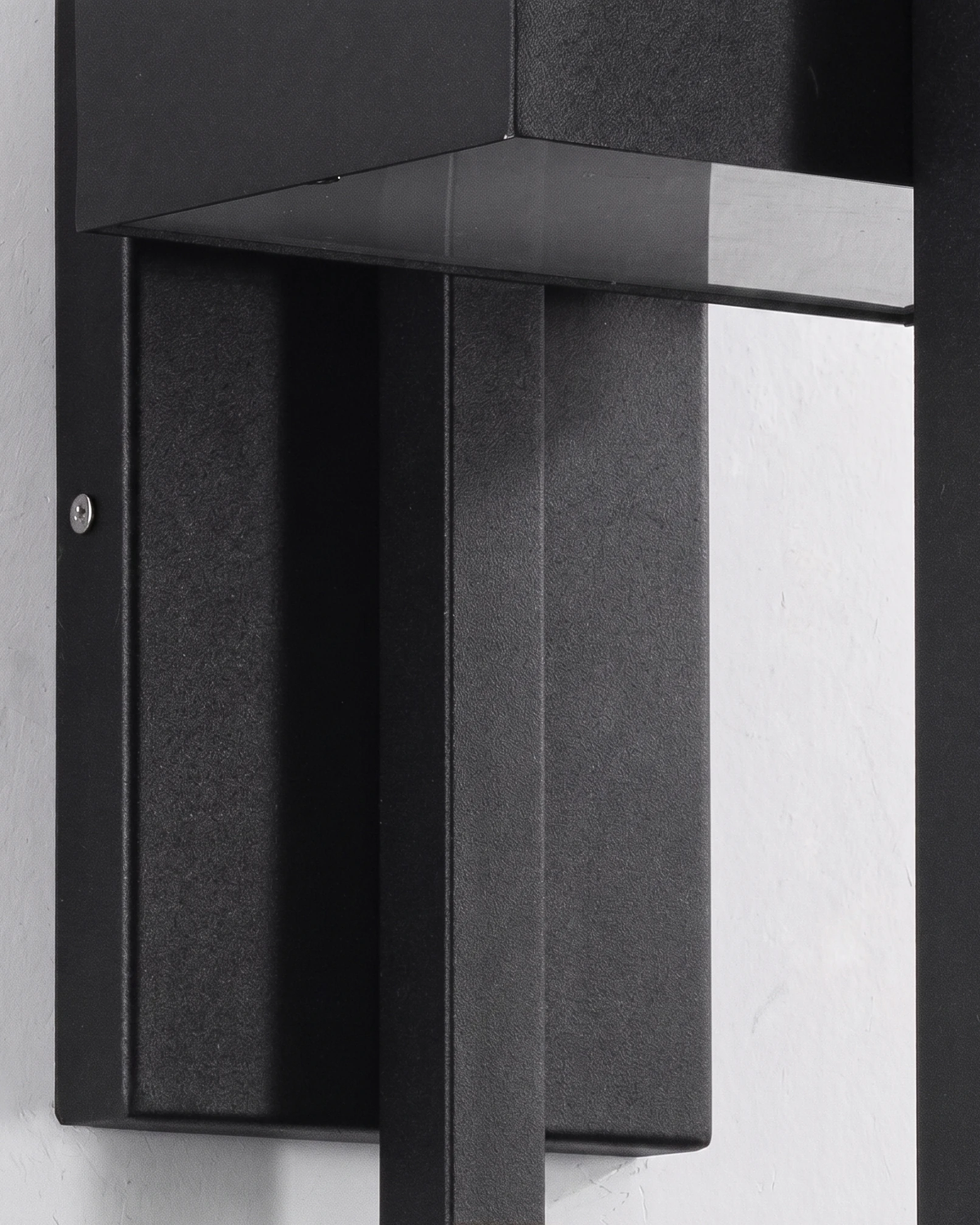 Close-up of the FERRO No.01 outdoor wall sconce mounting bracket and back plate in black steel