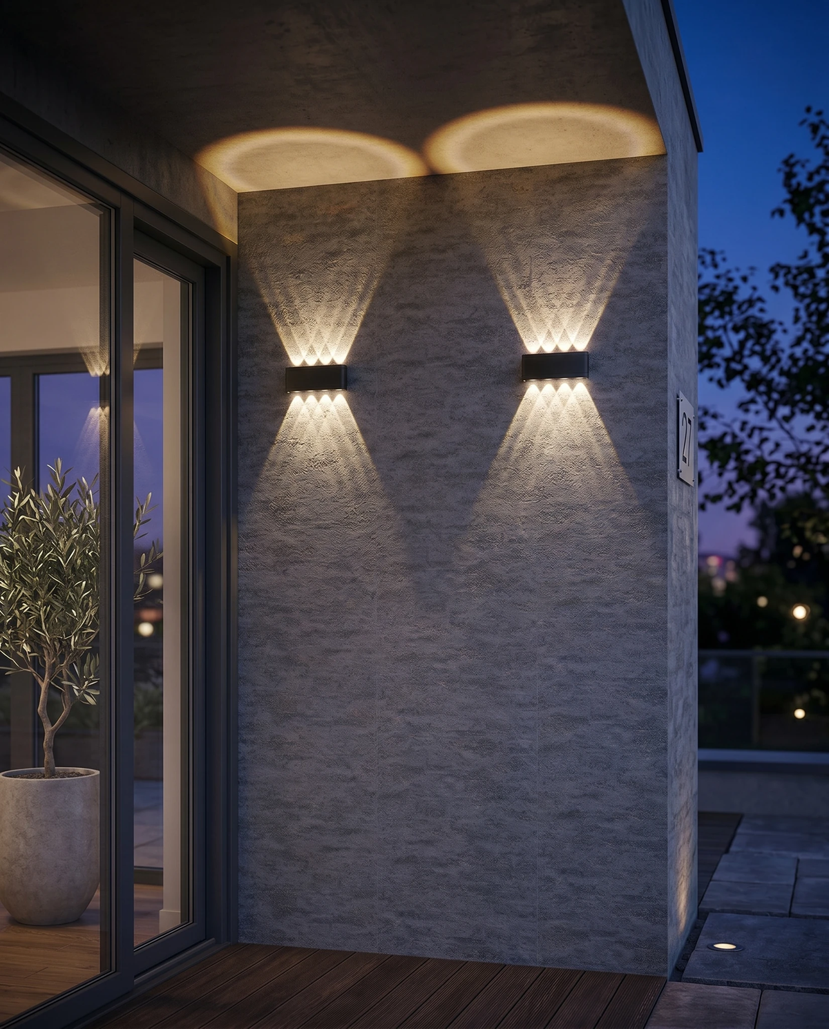 Outdoor wall sconce PALAZZO No.01 in matte black, two units lit on a stone-clad wall beside sliding glass doors at dusk