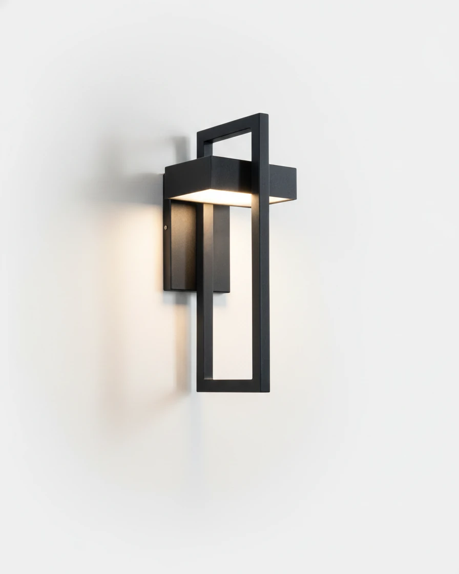 Outdoor wall sconce FERRO No.01 standard size, matte black open-frame lantern lit against a plain white wall