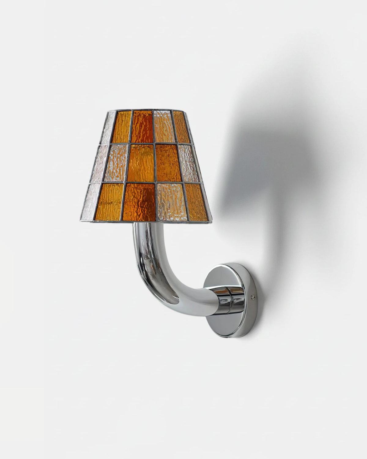 Stained glass wall sconce TESSERA No.01 in Amber Orange, checkered amber glass shade on a curved chrome arm, unlit