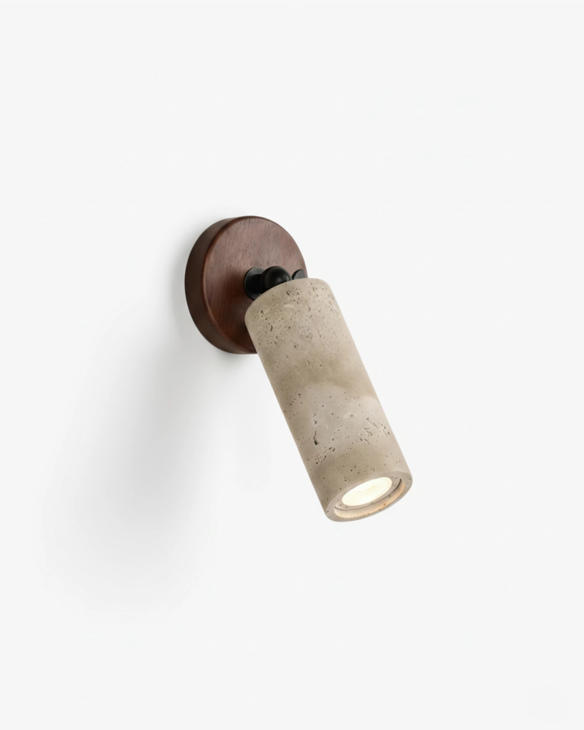 Stone-effect wall sconce MANTOVA No.01, adjustable stone-effect spot on a walnut backplate, switched on, angled on white