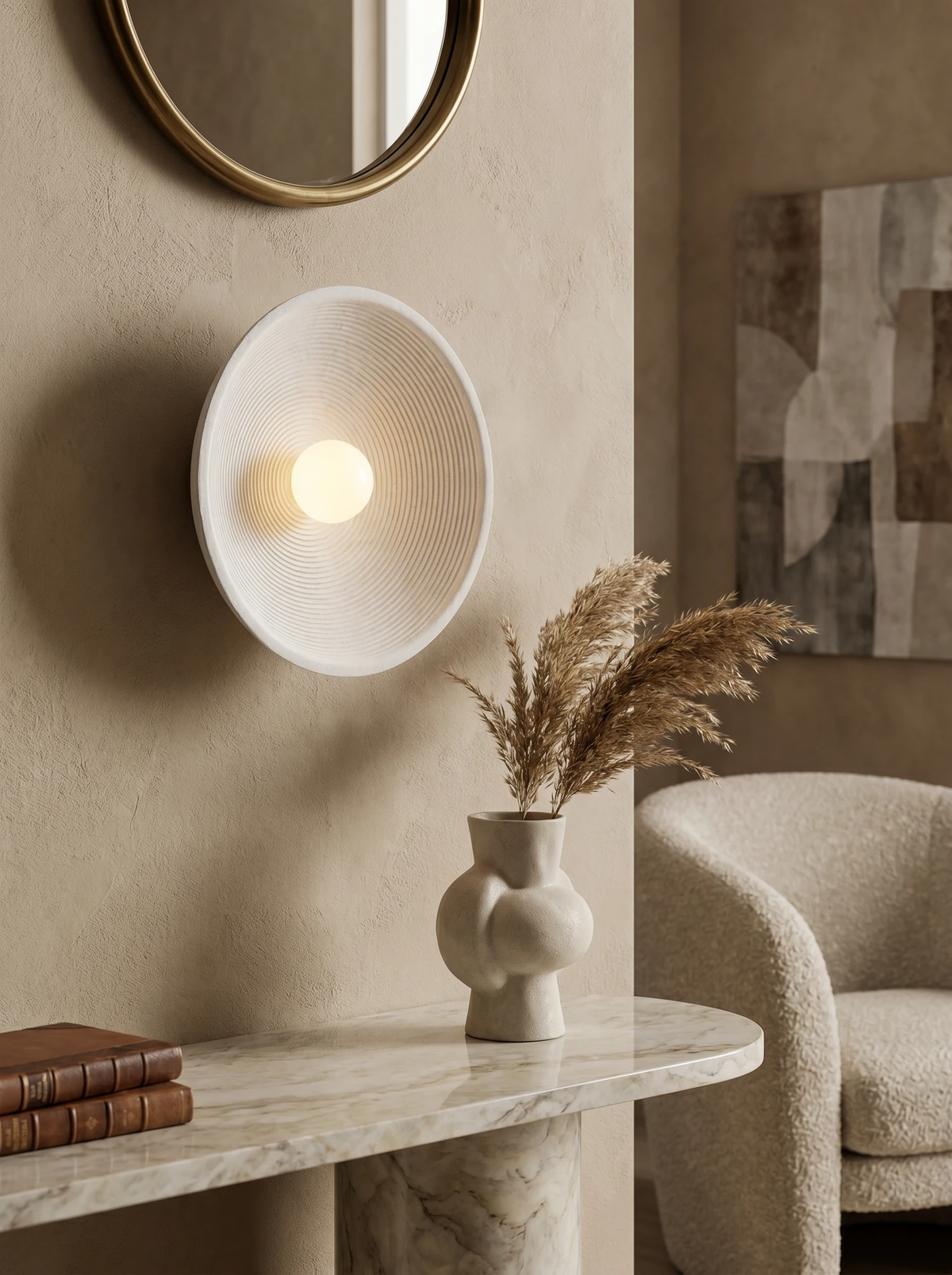 Stone-look wall sconce ECCO No.01 in warm cream, lit on a plaster wall above a marble console with a vase