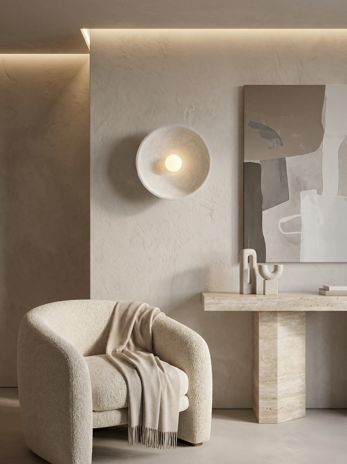 Stone-look wall sconce ECCO No.01 in warm cream, lit on a plaster wall above a boucle armchair and travertine table
