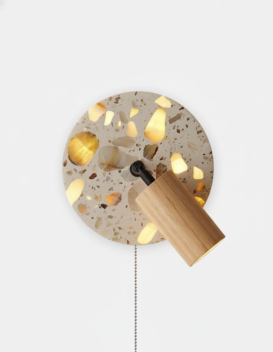 Terrazzo wall sconce PIETRA No.08 in Natural Ash, pale wood cylinder spot on a lit terrazzo plate with pull chain