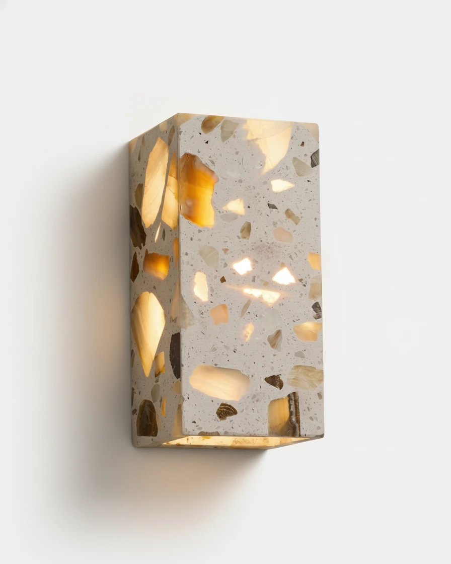 Terrazzo wall sconce INCA No.01 rectangle, translucent gray terrazzo block glowing from within on a white wall