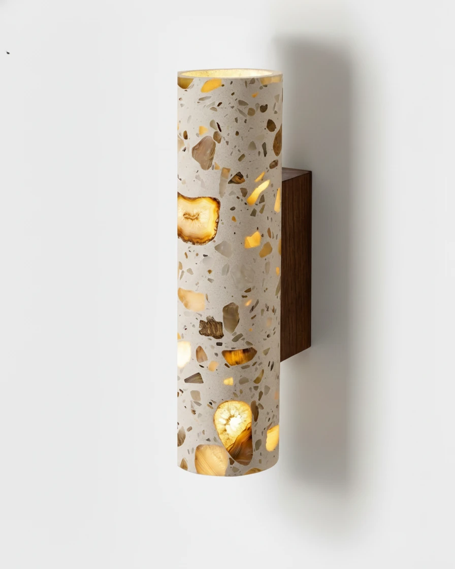Terrazzo wall sconce INCA No.02 standard size switched on, light showing through the terrazzo cylinder