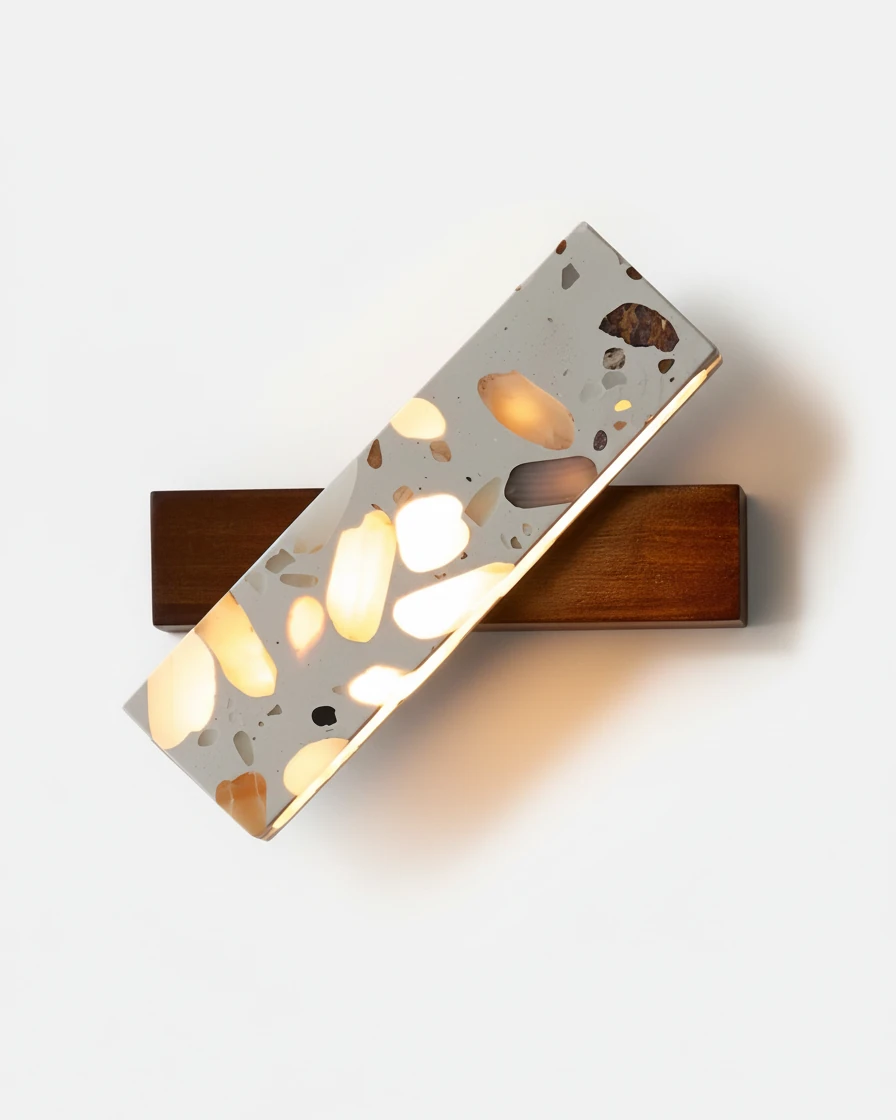 Terrazzo wall sconce PIETRA No.07 on a walnut base, tilted terrazzo bar switched on with glowing chips