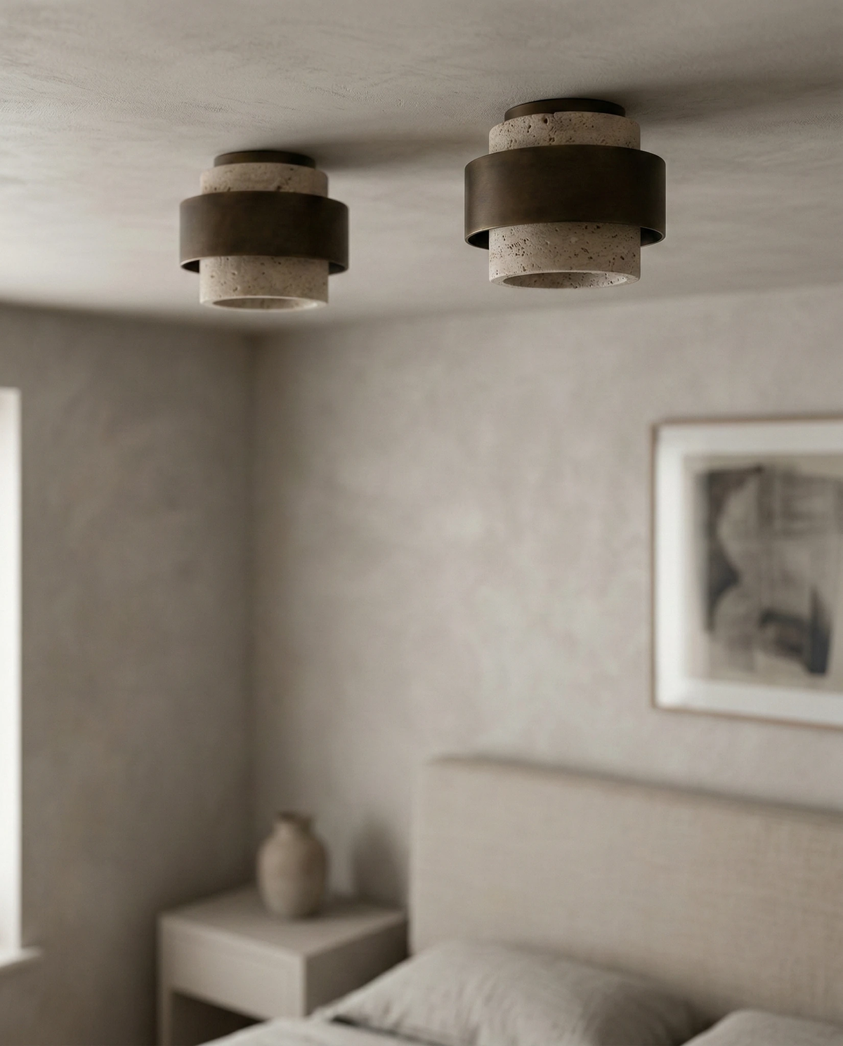 Travertine flush mount ceiling light DOMUS No.01, two lit units on the ceiling of a white bedroom