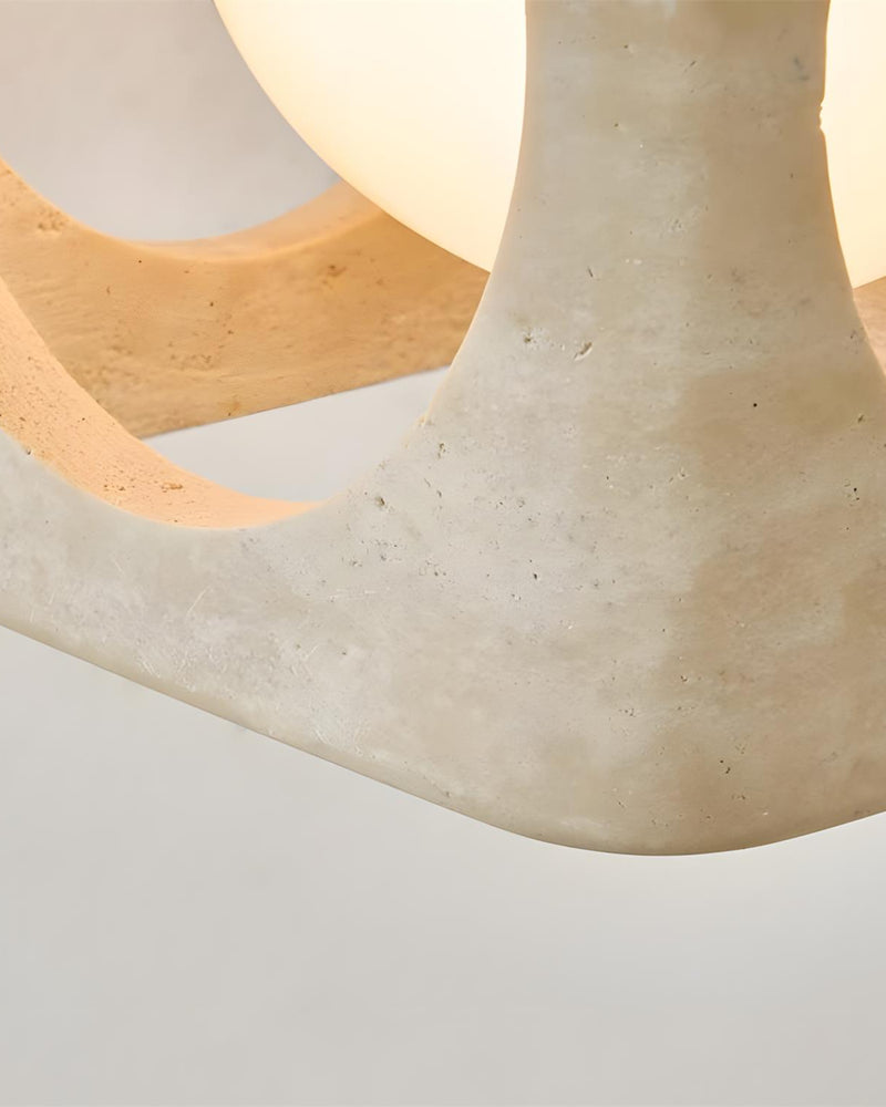 Close-up of the travertine cube edge and glowing opal globe on the travertine flush mount ceiling light CUBA No.01
