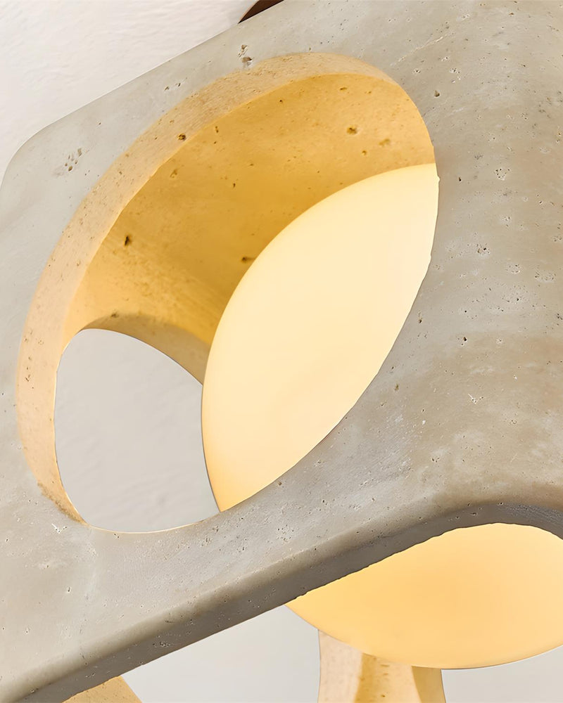 Close-up of a round cut-out in the travertine flush mount ceiling light CUBA No.01 revealing the lit sphere