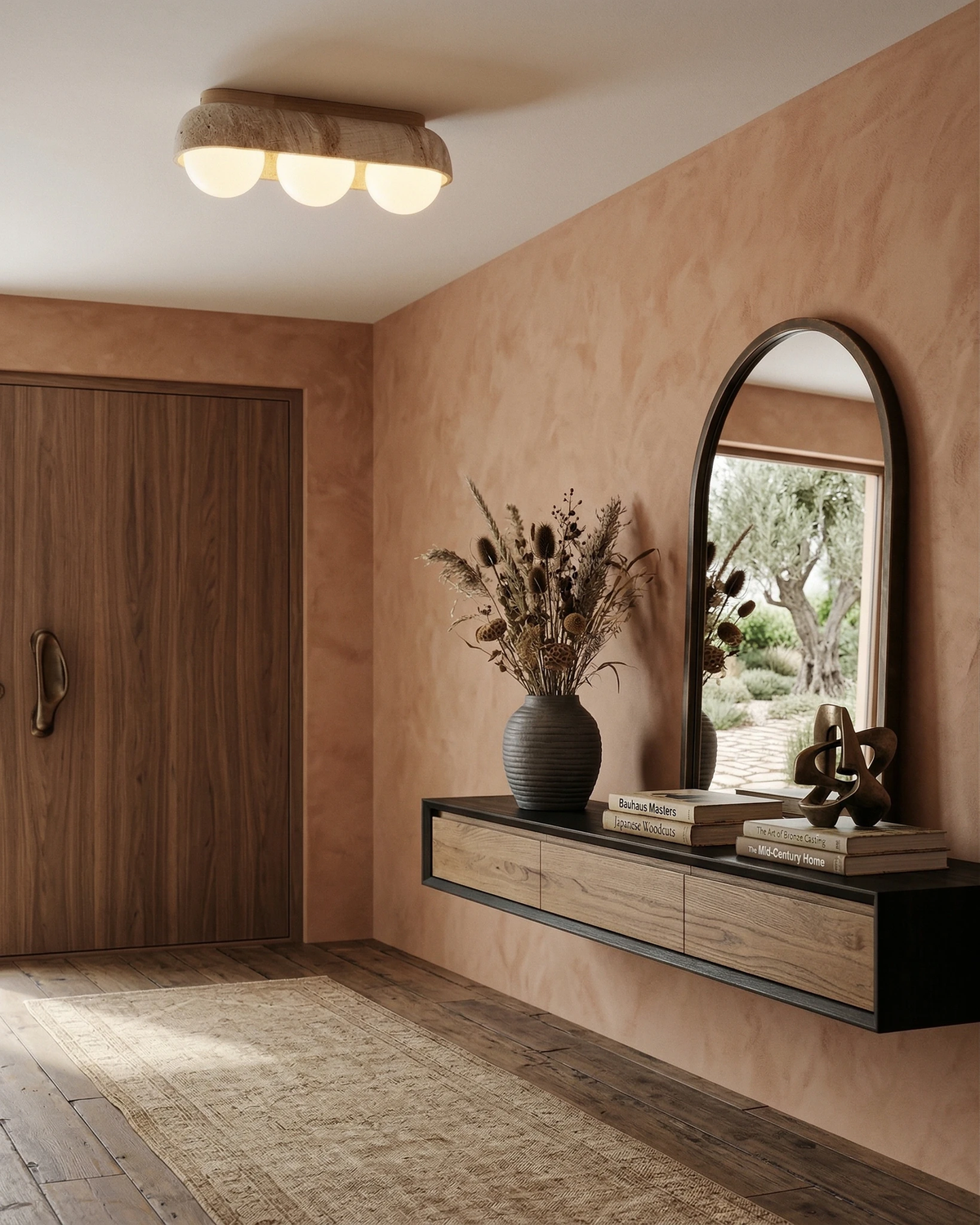 Travertine flush mount ceiling light PIETRA No.03 Three-Globe lit in a plaster entryway with an arched mirror and console