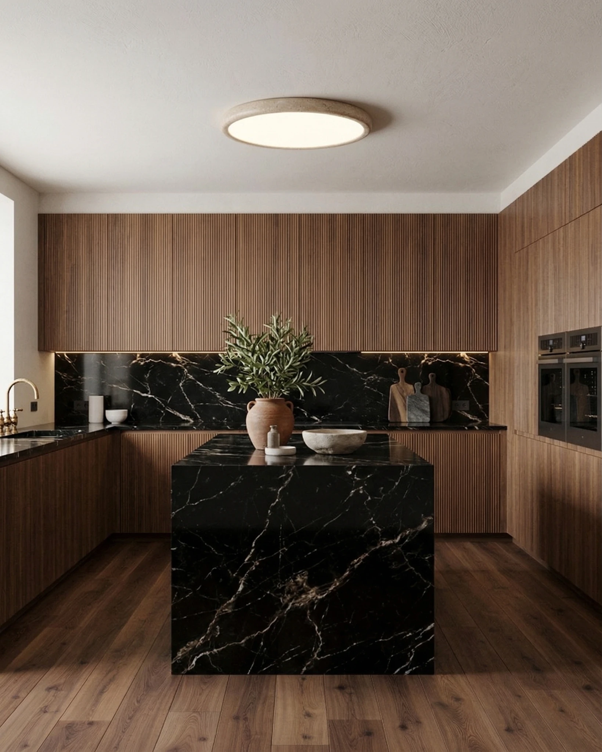 Travertine flush mount ceiling light LUNA No.05 switched on above a black marble island in a walnut kitchen