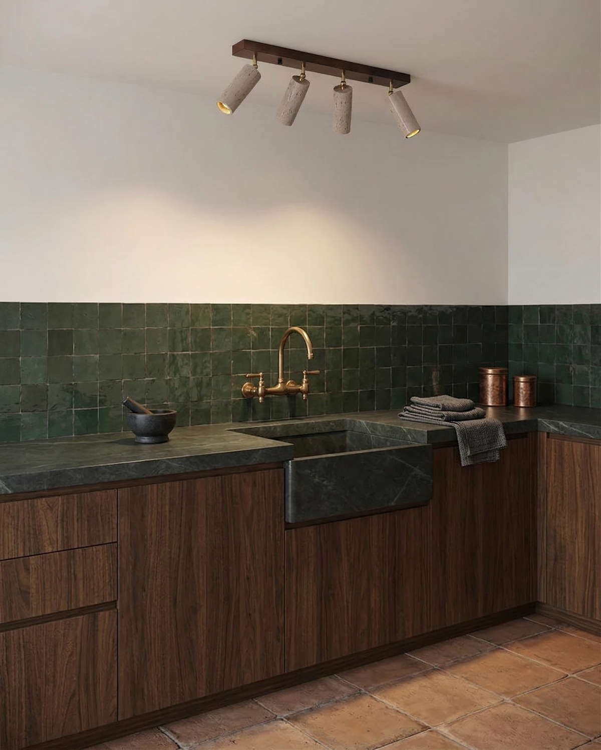 Travertine flush mount ceiling light PIETRA No.04 above a kitchen with green tile backsplash and walnut cabinets