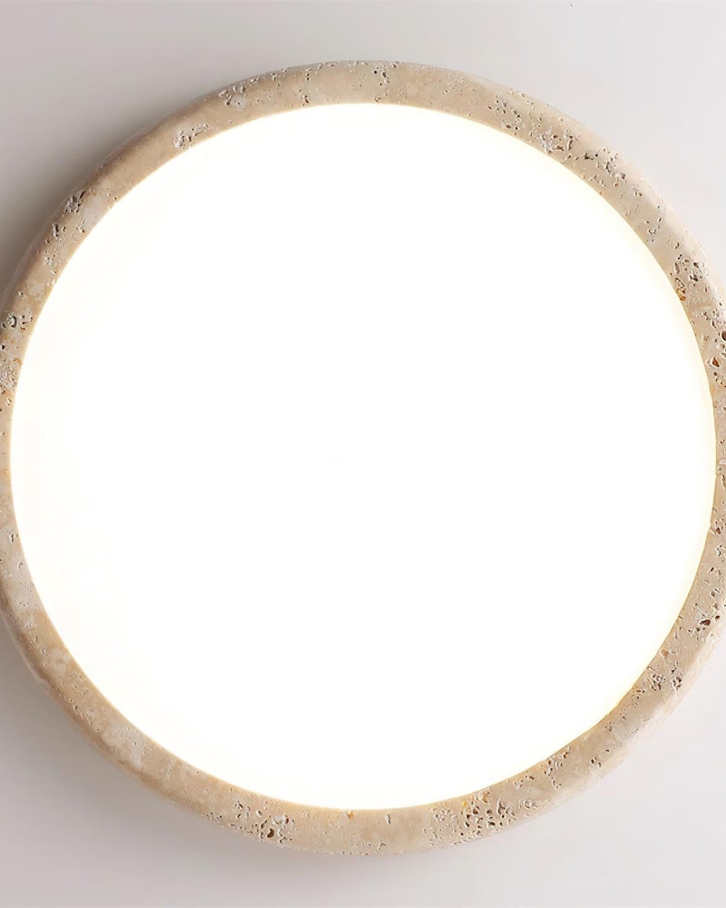 Travertine flush mount ceiling light LUNA No.05 seen straight from below, full disc lit with a travertine ring
