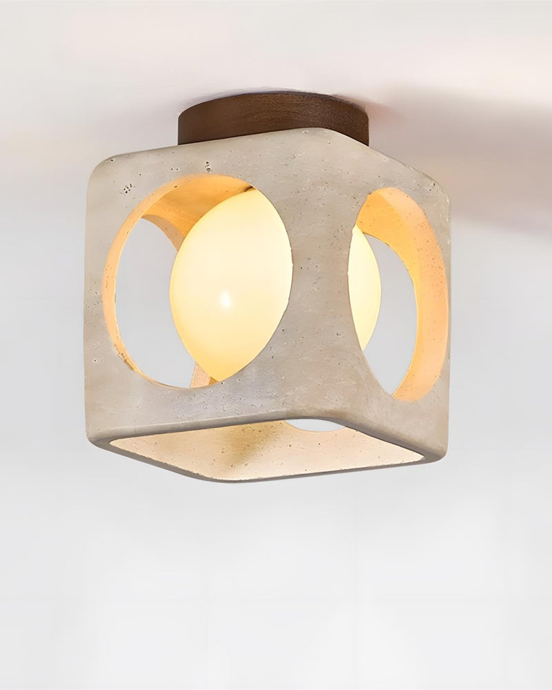 Travertine flush mount ceiling light CUBA No.01 lit, opal sphere glowing inside the open cube below a walnut plate