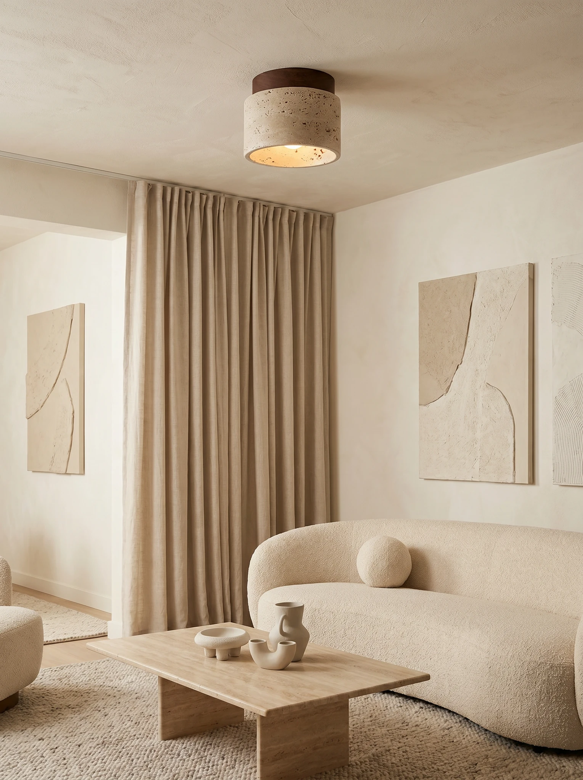 Travertine flush mount ceiling light VERTIN No.05 in cream, switched on above a curved boucle sofa and stone coffee table
