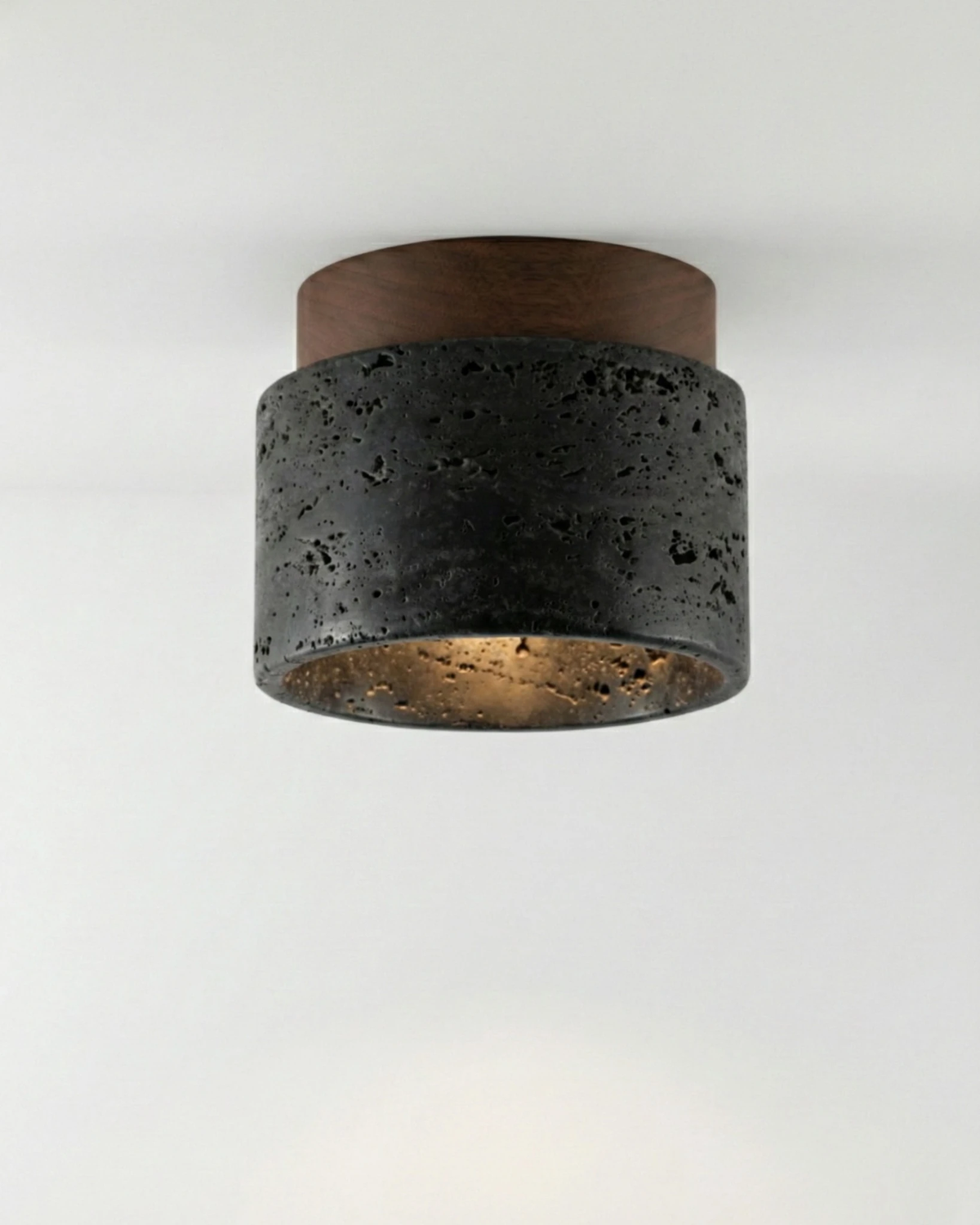 Travertine flush mount ceiling light VERTIN No.05 in Volcano Black, dark pitted stone drum under a walnut cap