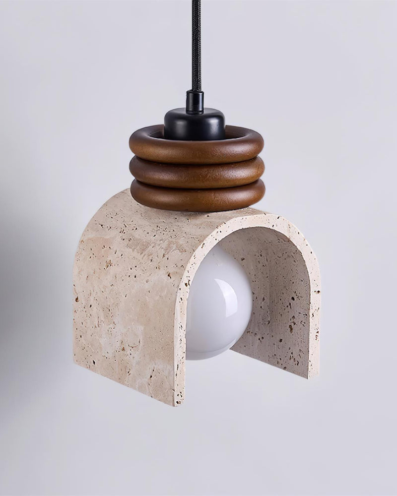 Travertine pendant light ARCA No.02 unlit, vaulted travertine shade with the white bulb visible under walnut rings