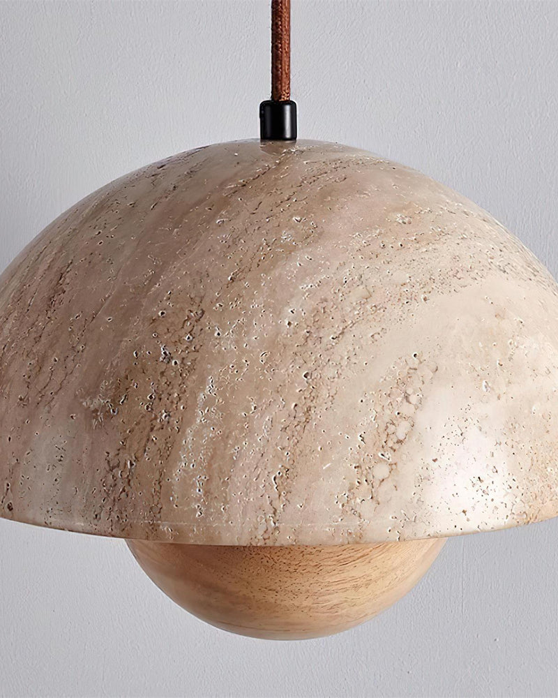 Close-up of the SOLE No.01 travertine pendant light with natural wood sphere, unlit, brown cord above