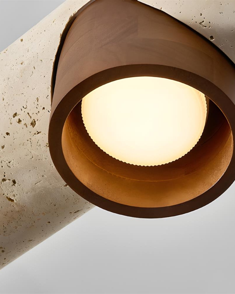 Close-up from below of a lit walnut cone shade on the PIETRA No.06 travertine pendant light
