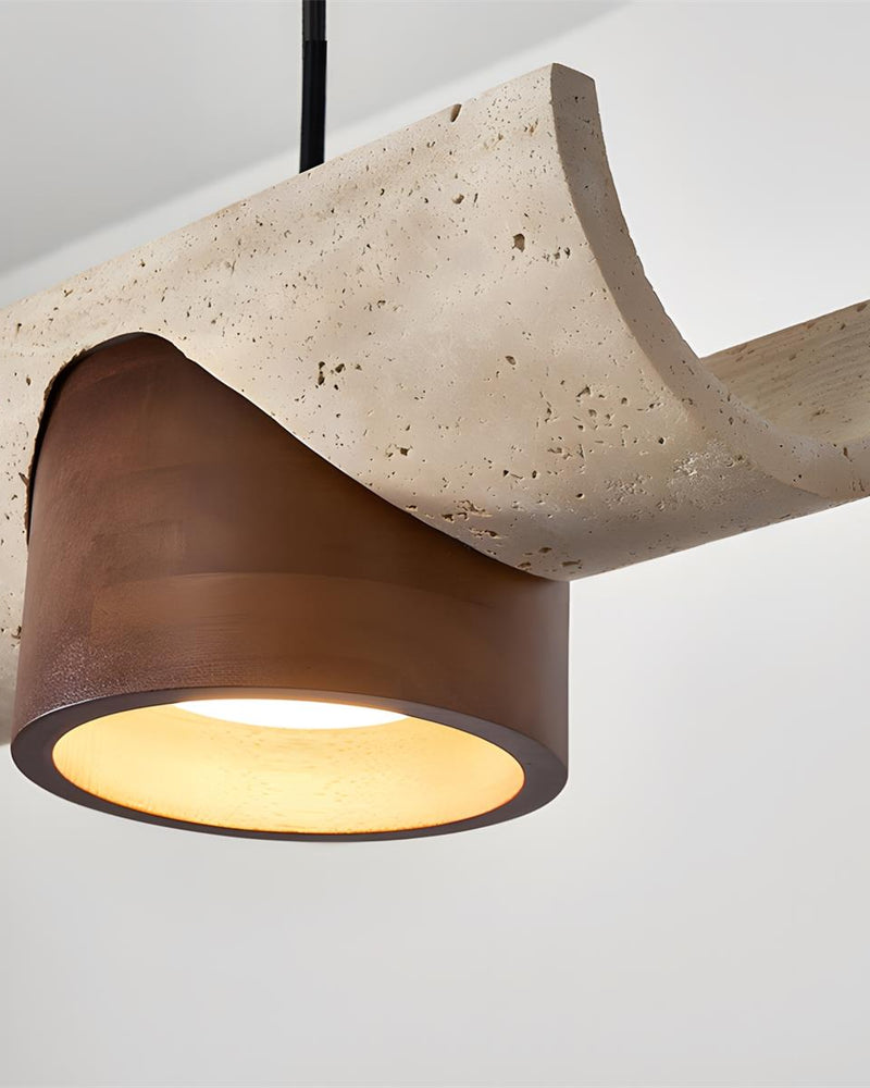 Close-up of the travertine bar and a glowing walnut cone with black cord on the PIETRA No.06 travertine pendant light