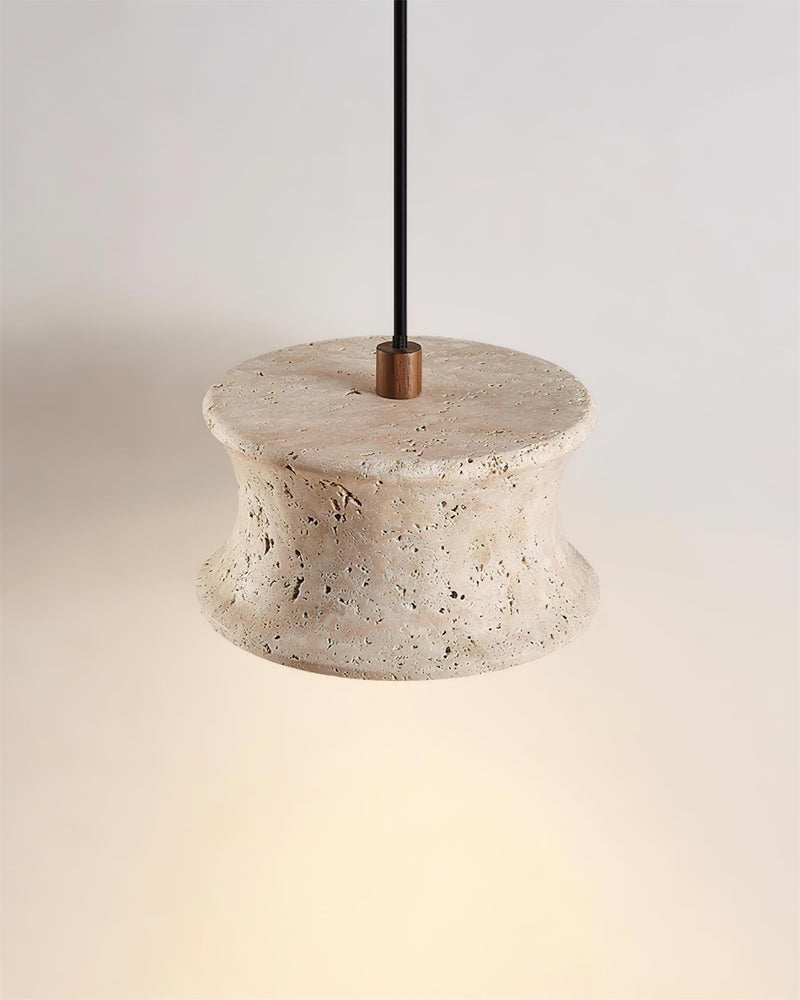 Close-up of the travertine pendant light CONA No.04 Solo, cream travertine flared shade with a brass top fitting, lit