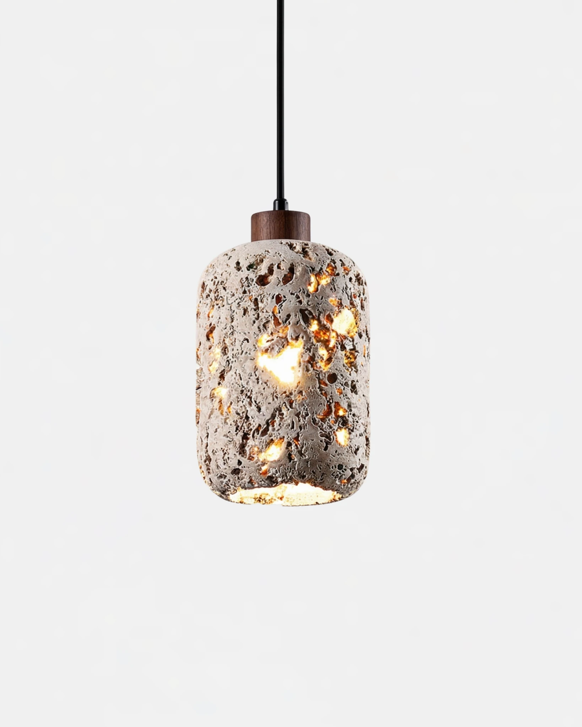 Travertine pendant light MASSA No.01, pored travertine cylinder with walnut cap glowing through its holes