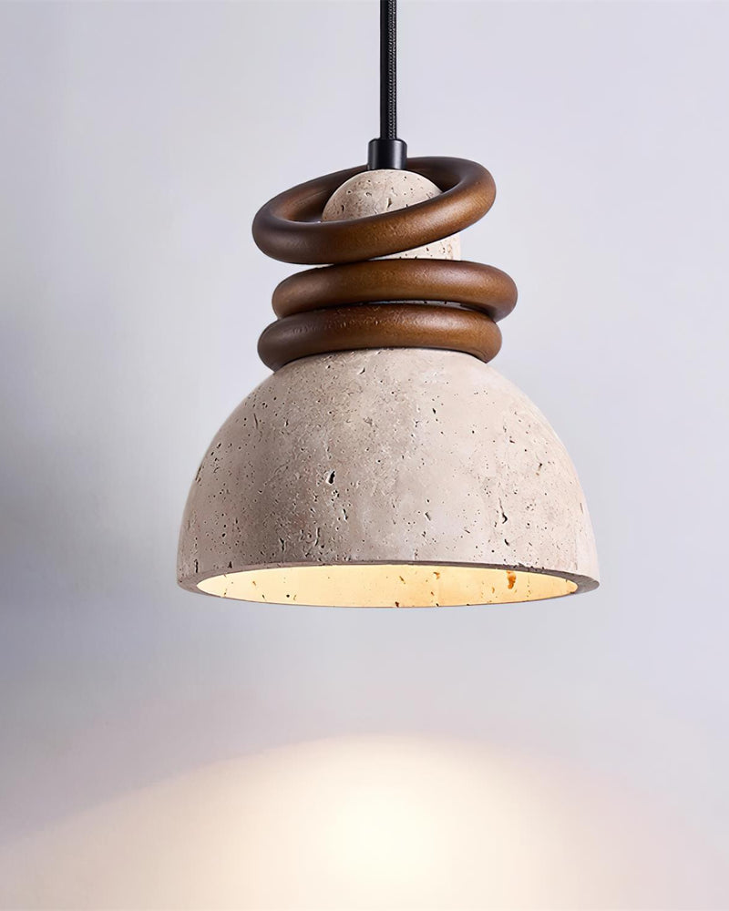 Travertine pendant light DOMUS No.03 single, switched on, dome glowing beneath walnut rings on a grey background