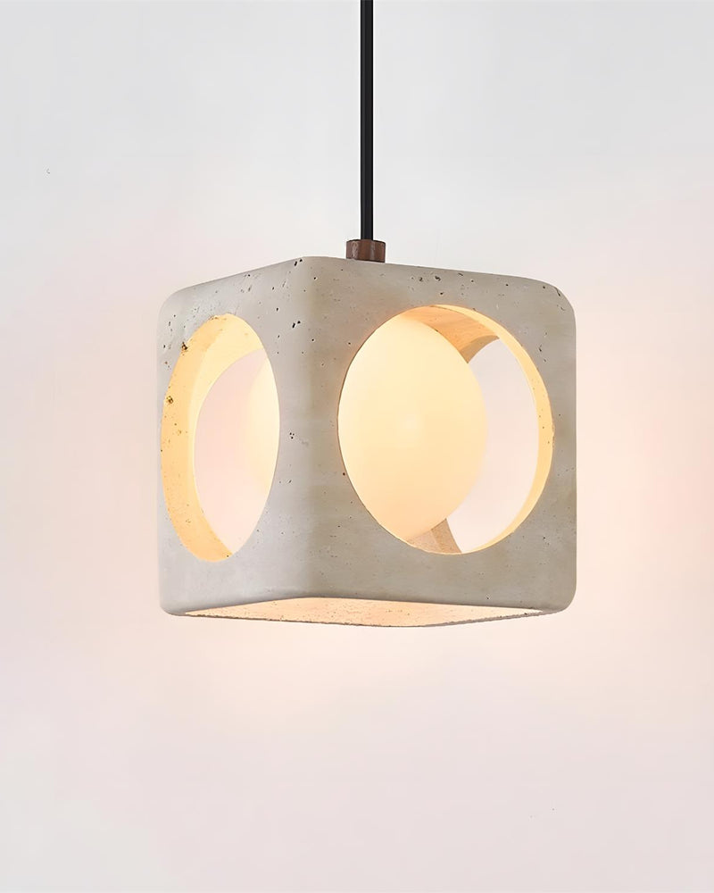 Travertine pendant light CUBA No.02 solo cube switched on, opal sphere glowing through the round portals