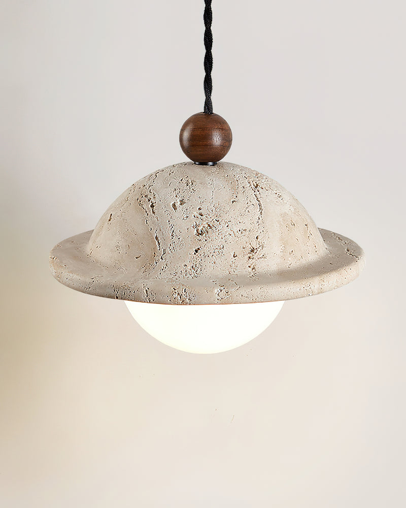 Travertine pendant light SOVA No.01 seen from slightly above, stone dome and rim with the opal globe glowing below