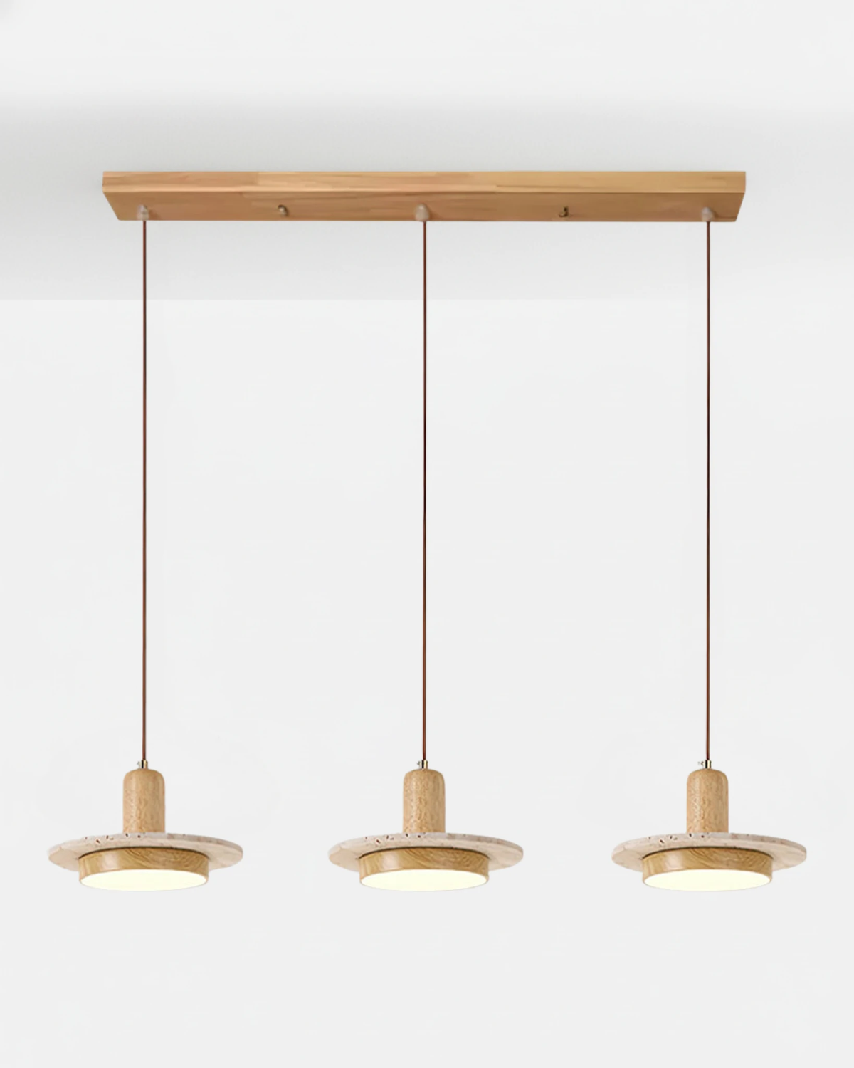 Travertine pendant light SOVA No.02 Triple in Light Oak, three glowing travertine discs on a light oak bar