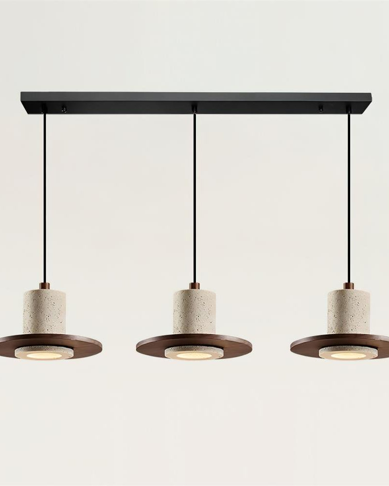 Three travertine pendant lights TONDO No.04 Linear Trio, drums on walnut saucers in a row under a black ceiling bar, lit