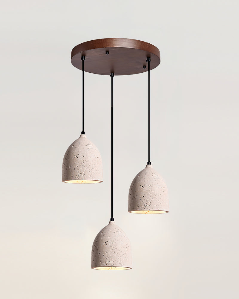 Set of three travertine pendant lights BOCCA No.01 on a round walnut canopy at staggered heights, lit
