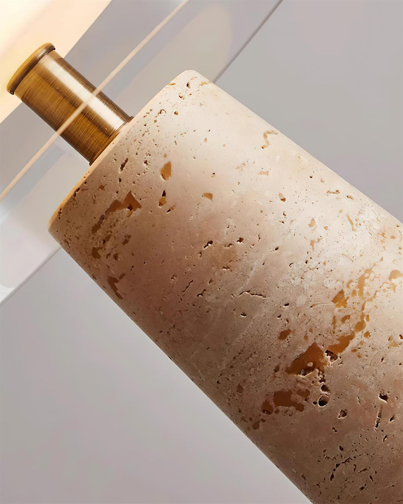 Close-up of the travertine table lamp MORA No.01 stone column with its brass stem rising into the glass dome