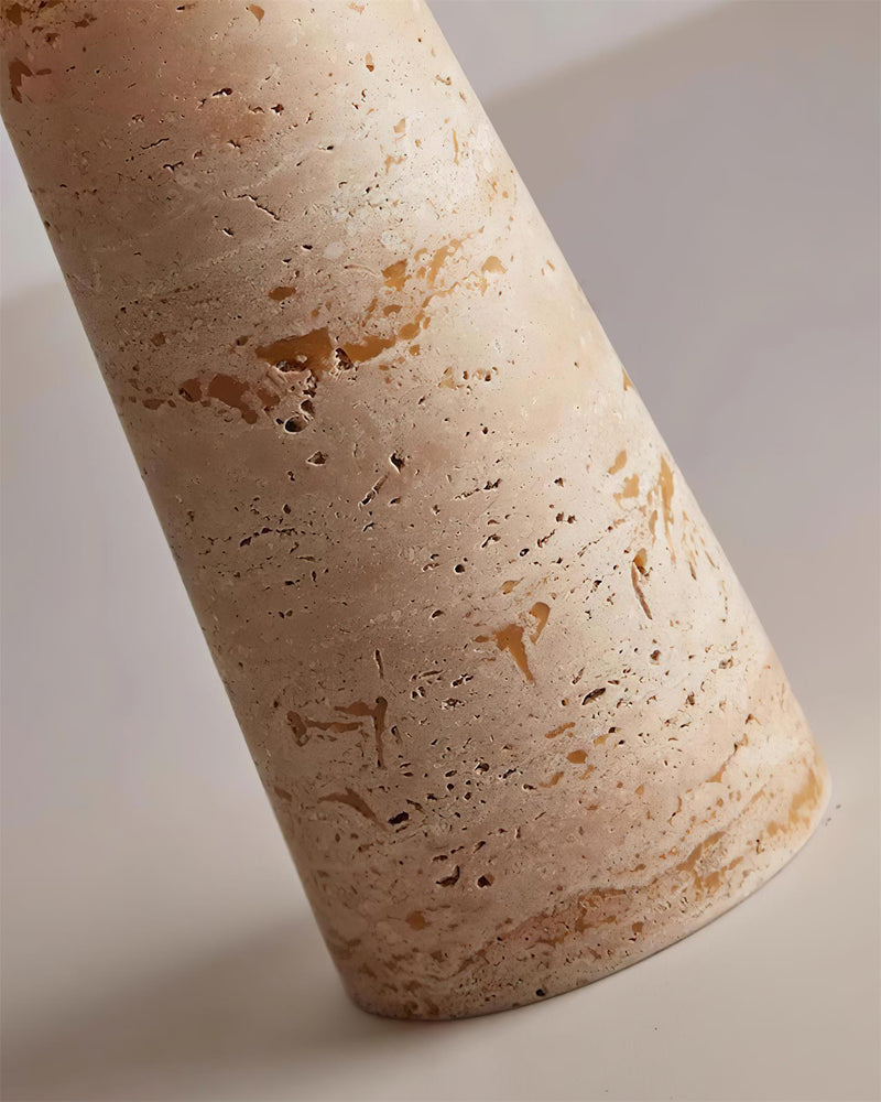 Close-up of the tapered travertine column of the MORA No.01 table lamp showing the natural pitted stone veining