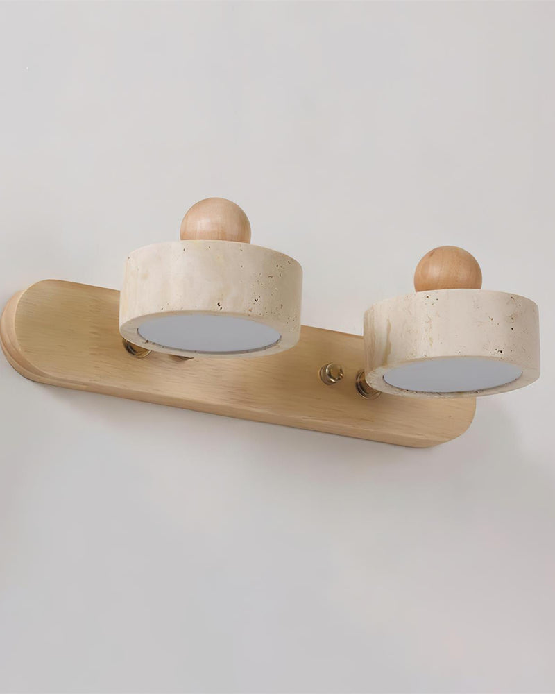 Travertine vanity light PIETRA No.02, double head in light walnut seen from a low angle, drums tilted, unlit