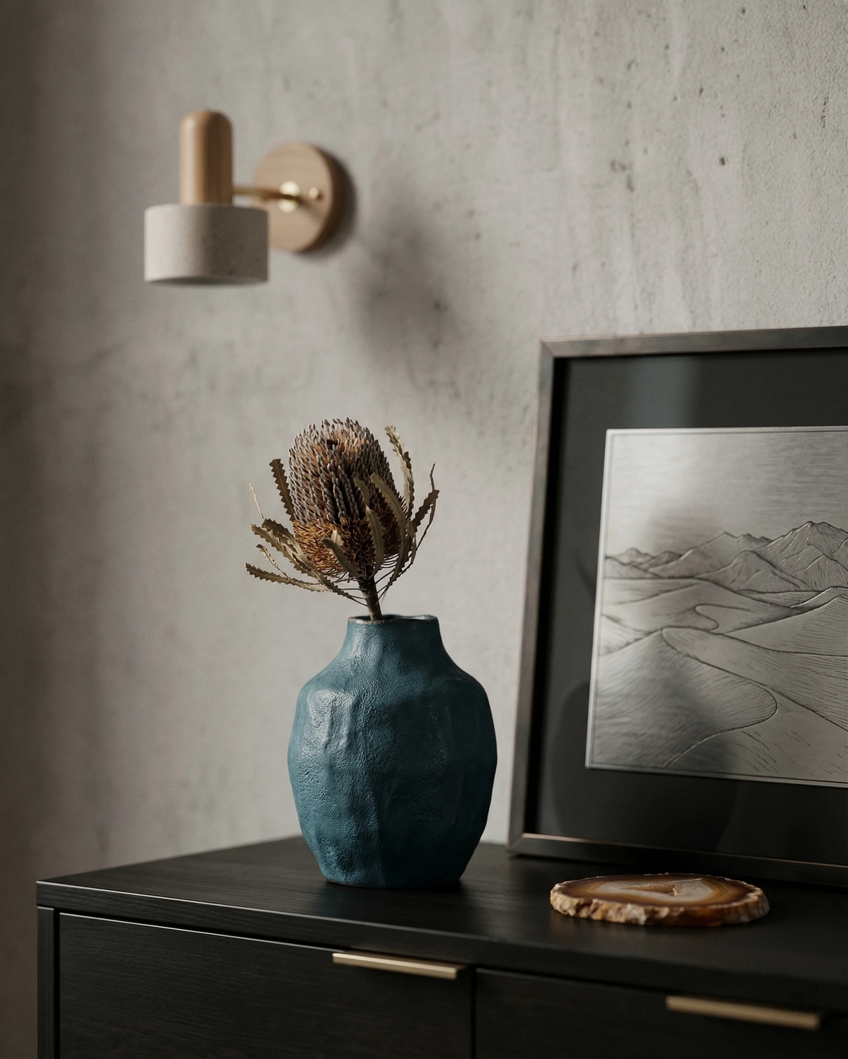 Travertine wall sconce CONA No.01, cylinder head on light oak, unlit above a black dresser with a blue vase