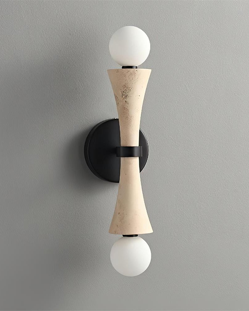 Travertine wall sconce VETTA No.01, cream hourglass stone with opal globes top and bottom, unlit on a gray wall