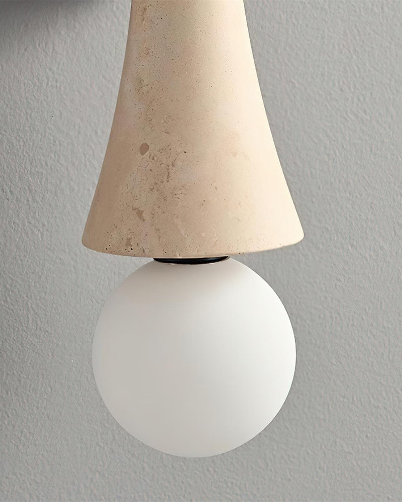 Close-up of the lower opal globe under the cream travertine cone of the travertine wall sconce VETTA No.01