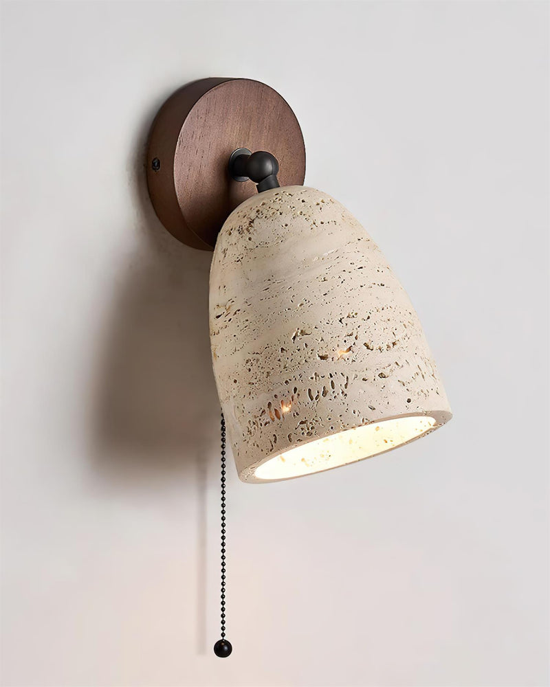 Travertine wall sconce PERA No.01 switched on, cream travertine dome on a round walnut plate with pull chain
